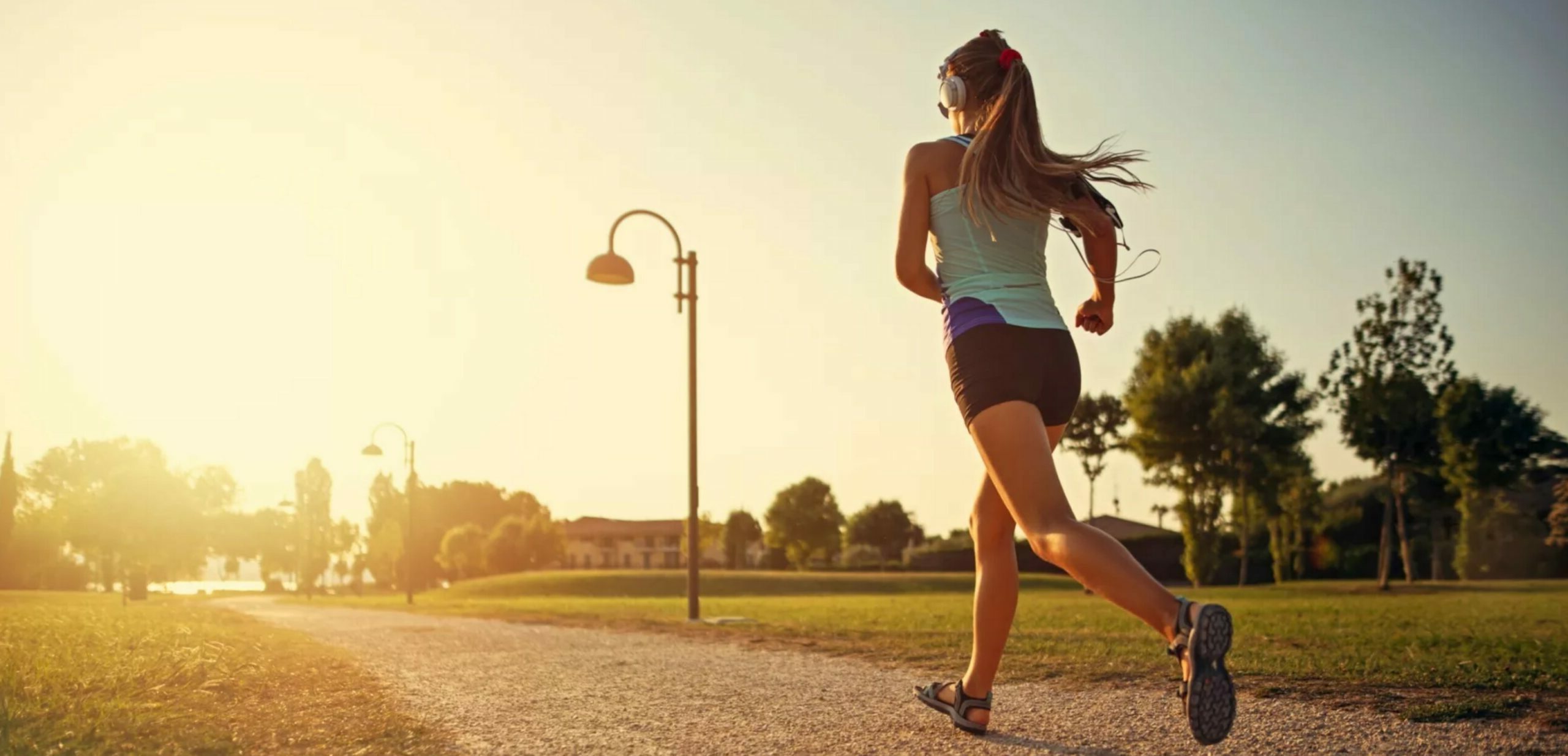 young woman jogging by the light of the evening sun
