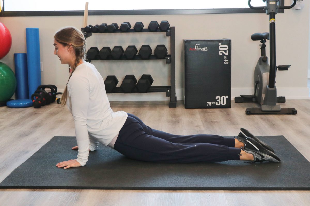 Woman demonstrating upward dog position at Cornerstone Physiotherapy in Burlington