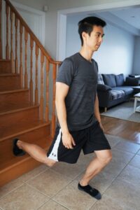 man performing a split squat coming down from stairs