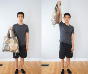 man using a grocery bag to curl up and lift overhead with one arm