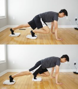 man performing an exercise on hands and feet with feet on towels