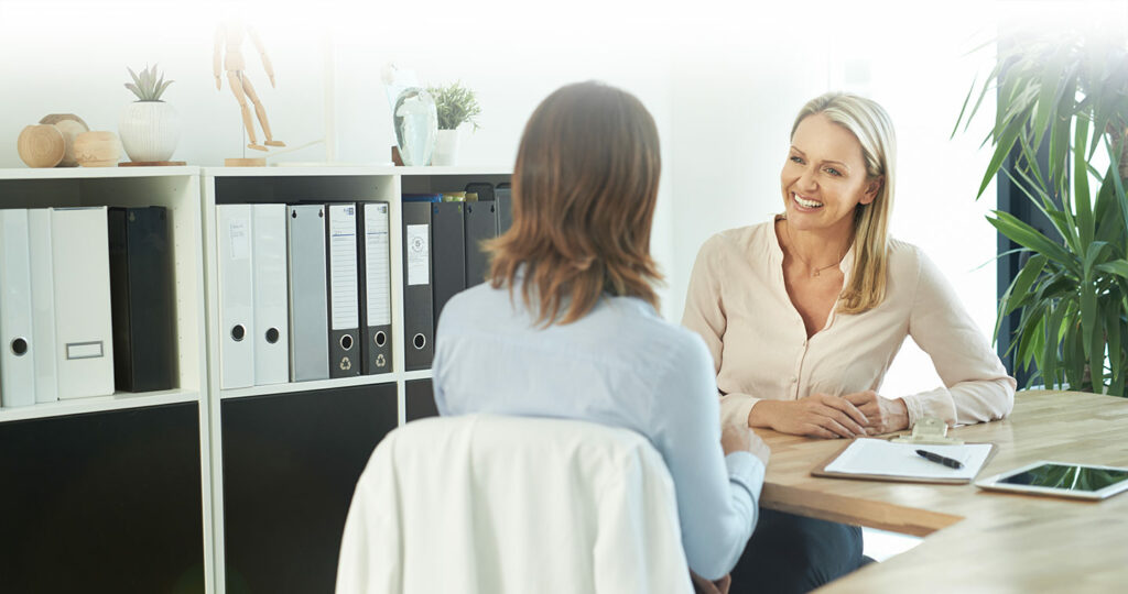 Two woman having a discussion in a physiotherapy consultation