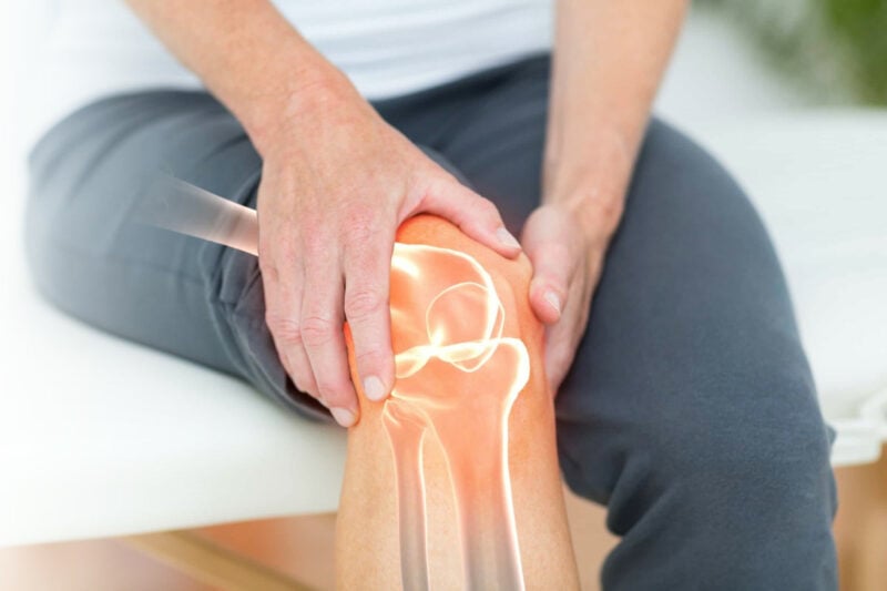 woman holding knee in pain due to osteoarthritis or arthritis