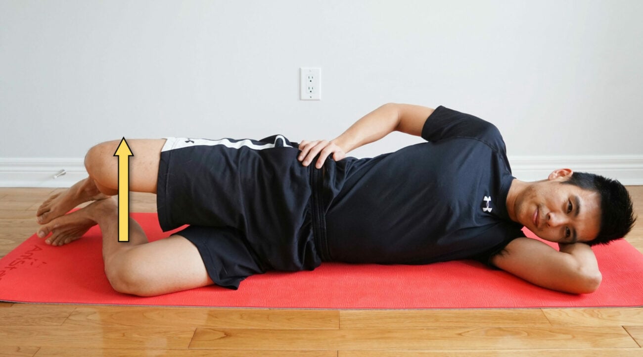 man performing clam shell exercises while side-lying