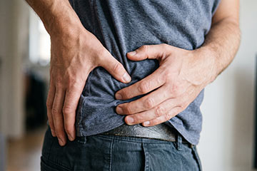 man-holding-his-hip-due-to-pain