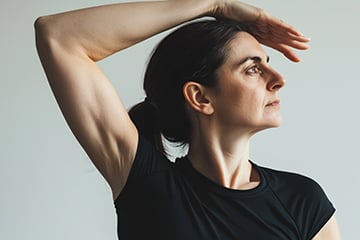 woman-post-breast-cancer-surgery-performing-a-rehabilitation-physiotherapy-stretch-with-her-right-arm-preview