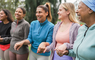 group-of-women-holding-hands-in-support-of-breast-cancer-rehabilitation-hero